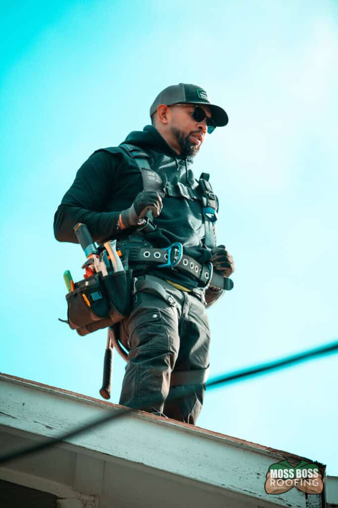 Roof inspection in Salem Oregon by Moss Boss Roofing checking shingles and flashing