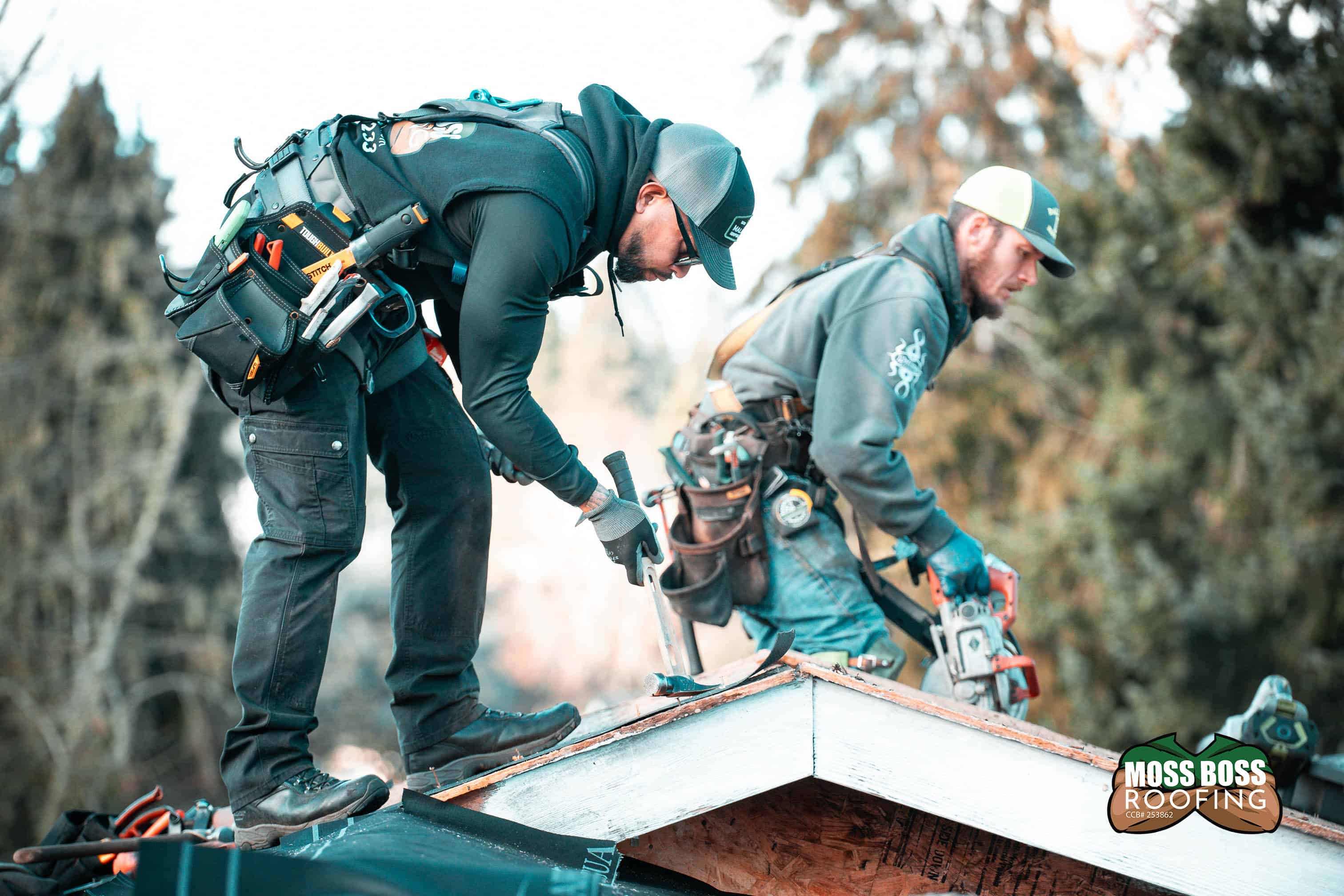 Roof replacement in Salem Oregon by Moss Boss Roofing crew installing asphalt shingles