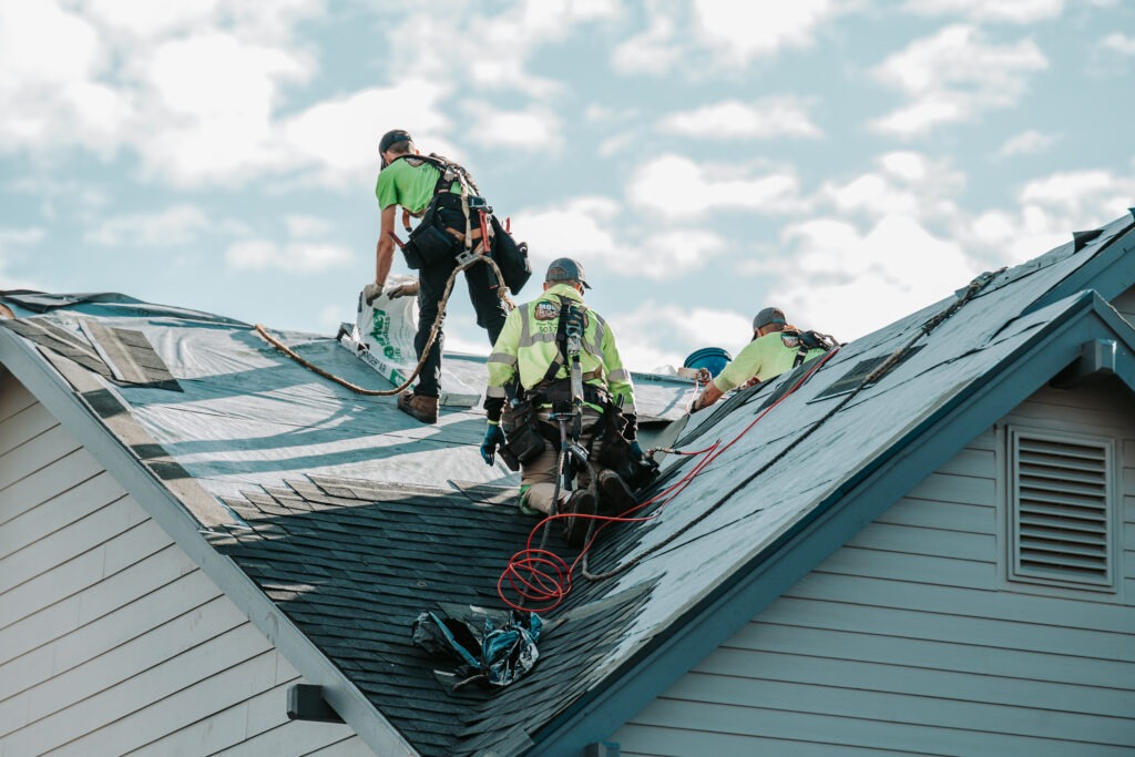 Local roof repair contractor inspecting damaged shingles in Salem Oregon