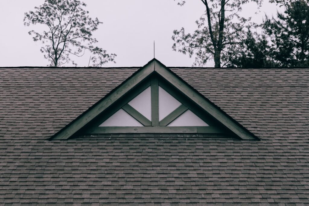 Asphalt-shingle roof with a small dormer on a residential home.